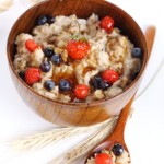 oat porridge with fresh berries isolated on a white background