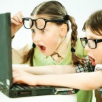 girl and boy looking at a computer
