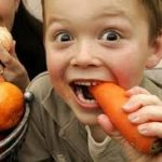 boy eating a carrot